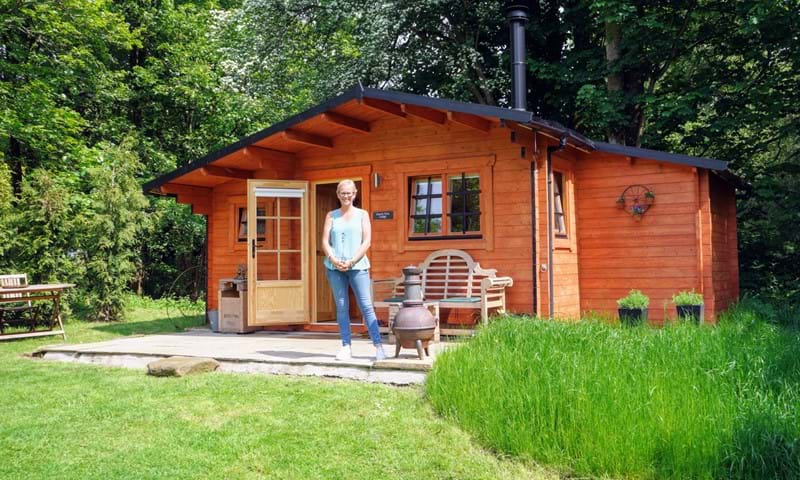 man outside of a cabin