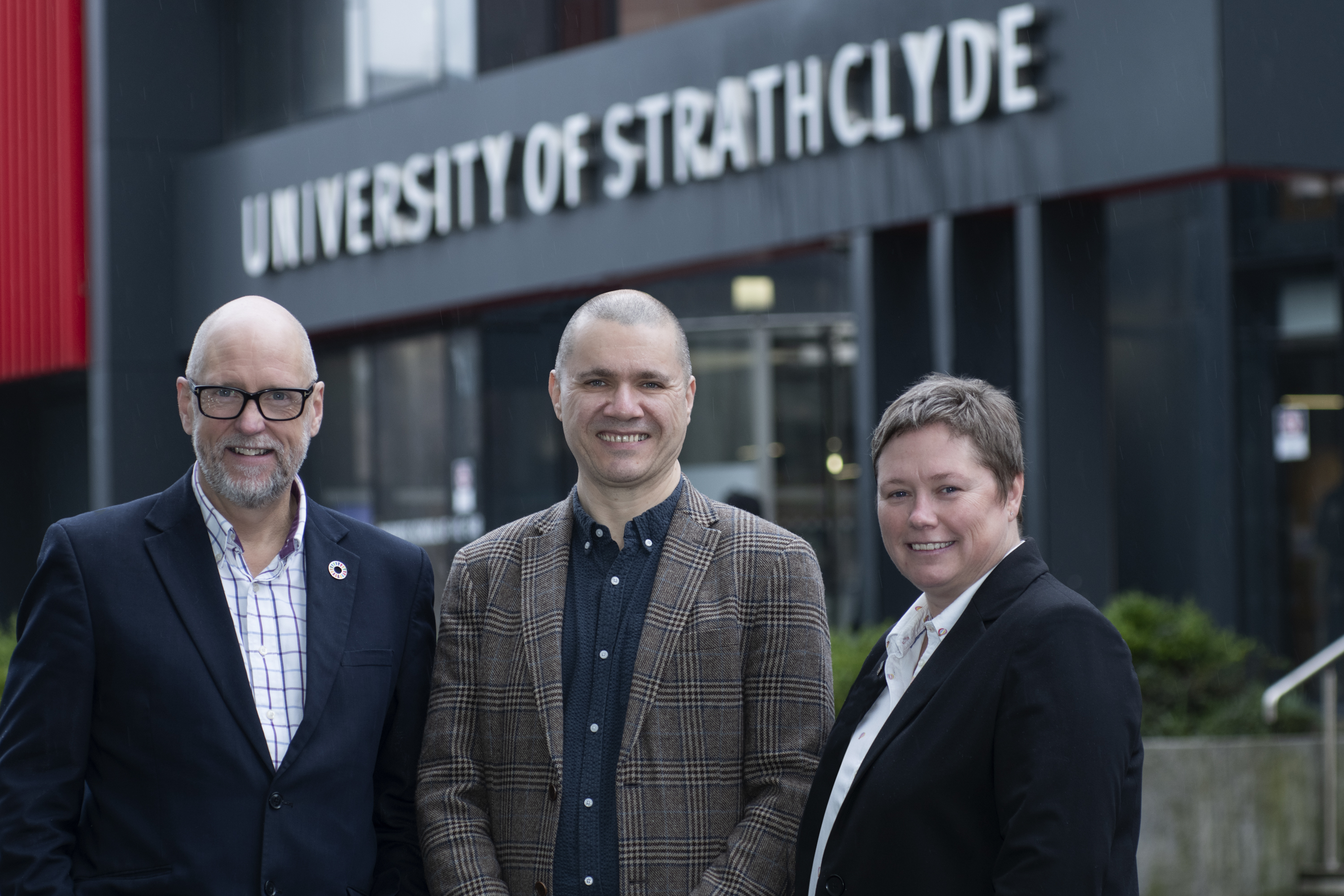 John Anderson, David Ritchie and Gillian Docherty are standing in front of Universty of Strathclyde building.