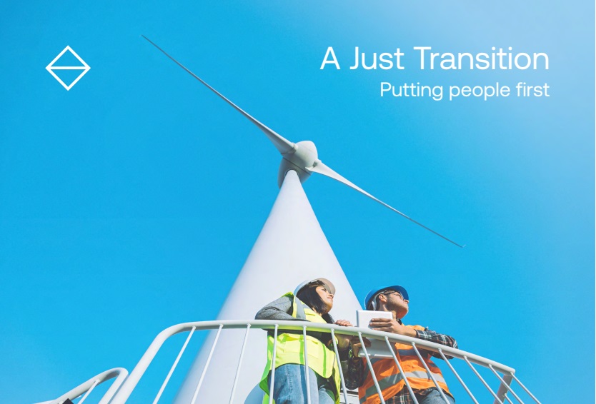 Wind turbine with two people in hard hats