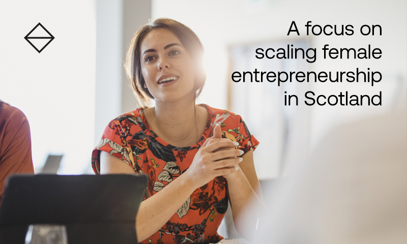 Female sitting in a meeting with laptop in view