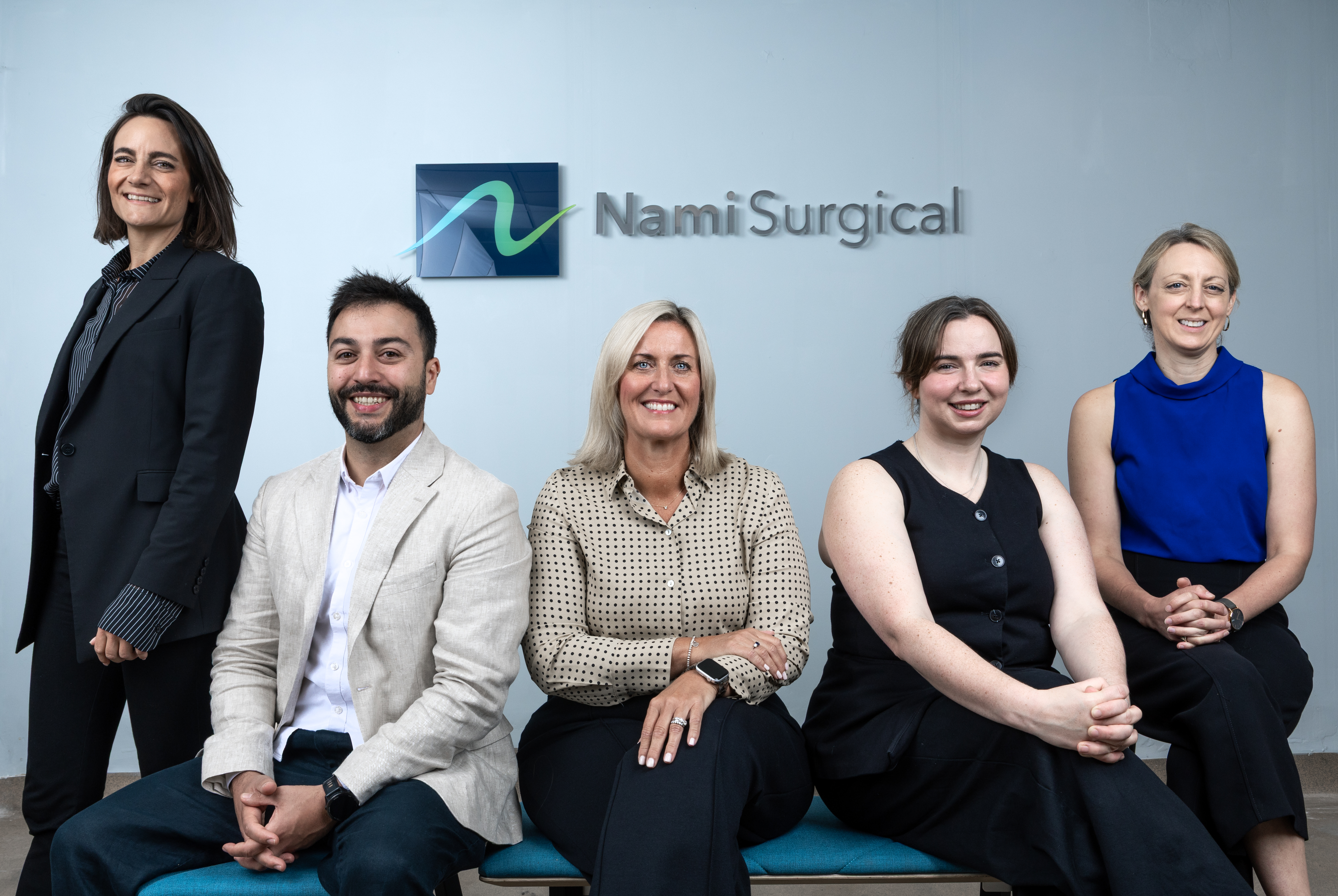 Nami team in front of Nami Surgical sign
