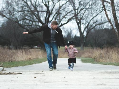 Man holding hands with a toddler