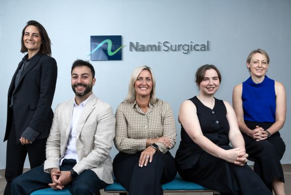 Nami team in front of Nami Surgical sign